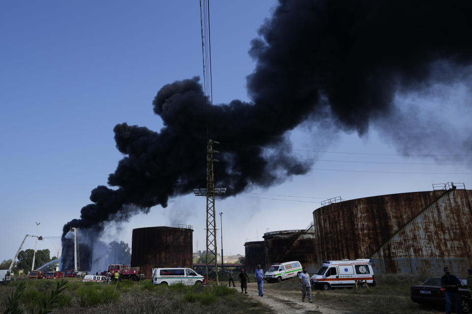 Smoke rises from an oil facility in the southern town of Zahrani, south of the port city of Sidon, Lebanon, Monday, Oct. 11, 2021. Firefighters extinguished the huge blaze that broke out in a storage tank at one of Lebanon's main oil facilities in the country's south Monday after it sent orange flames and a thick black column of smoke into the sky. (AP Photo/Hassan Ammar)