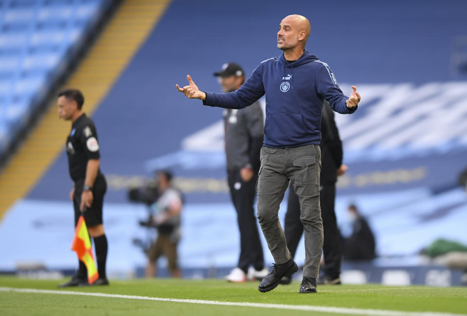 Manchester City's head coach Pep Guardiola gestures during the English Premier League soccer match between Manchester City and Liverpool at Etihad Stadium in Manchester, England, Thursday, July 2, 2020. (AP Photo/Laurence Griffiths,Pool)