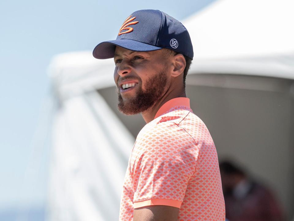 Stephen Curry looks on during a golf tournament.