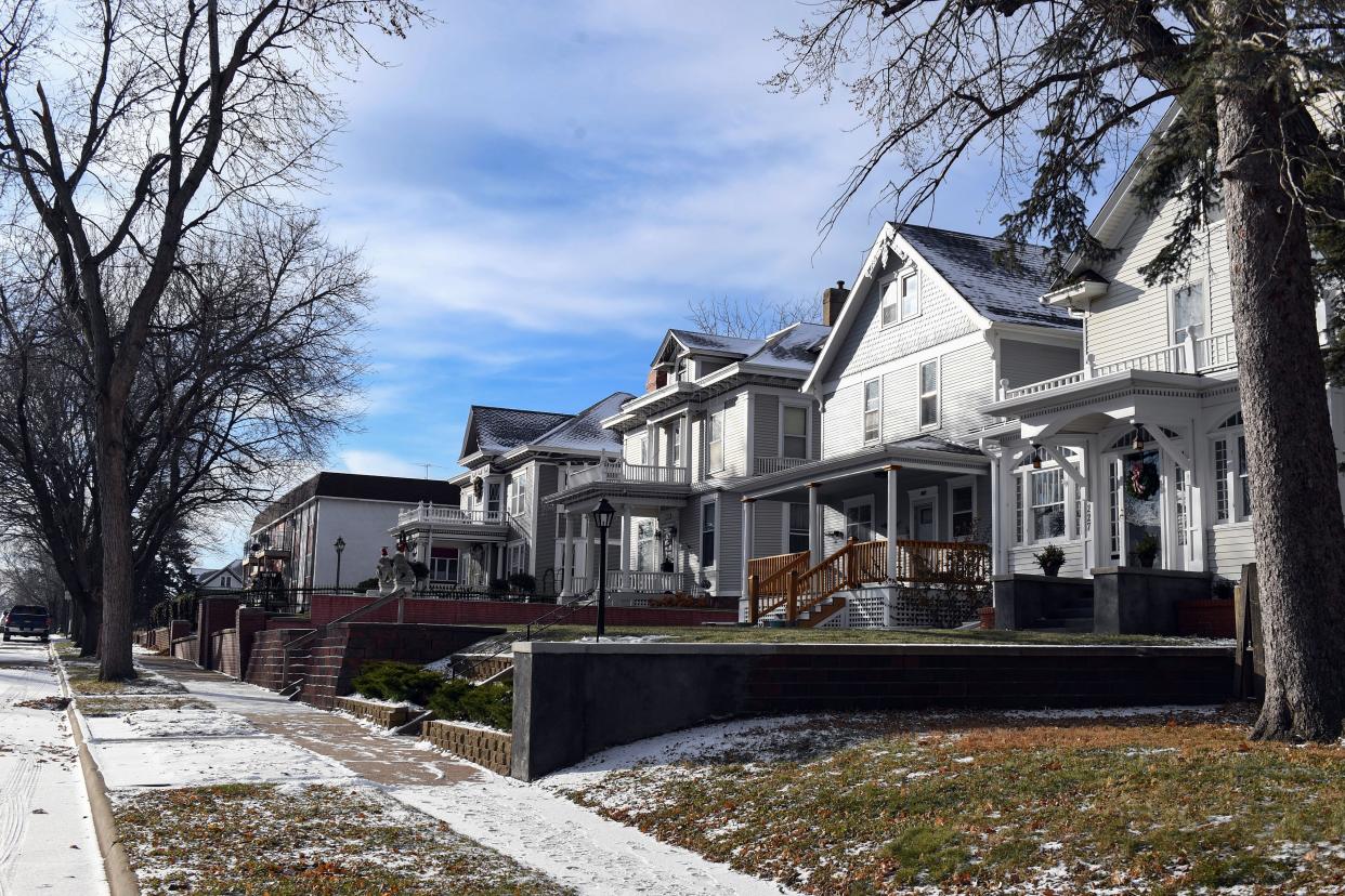 A light snow settles on the ground around houses in the historic Cathedral District on Wednesday, December 8, 2021, in Sioux Falls.