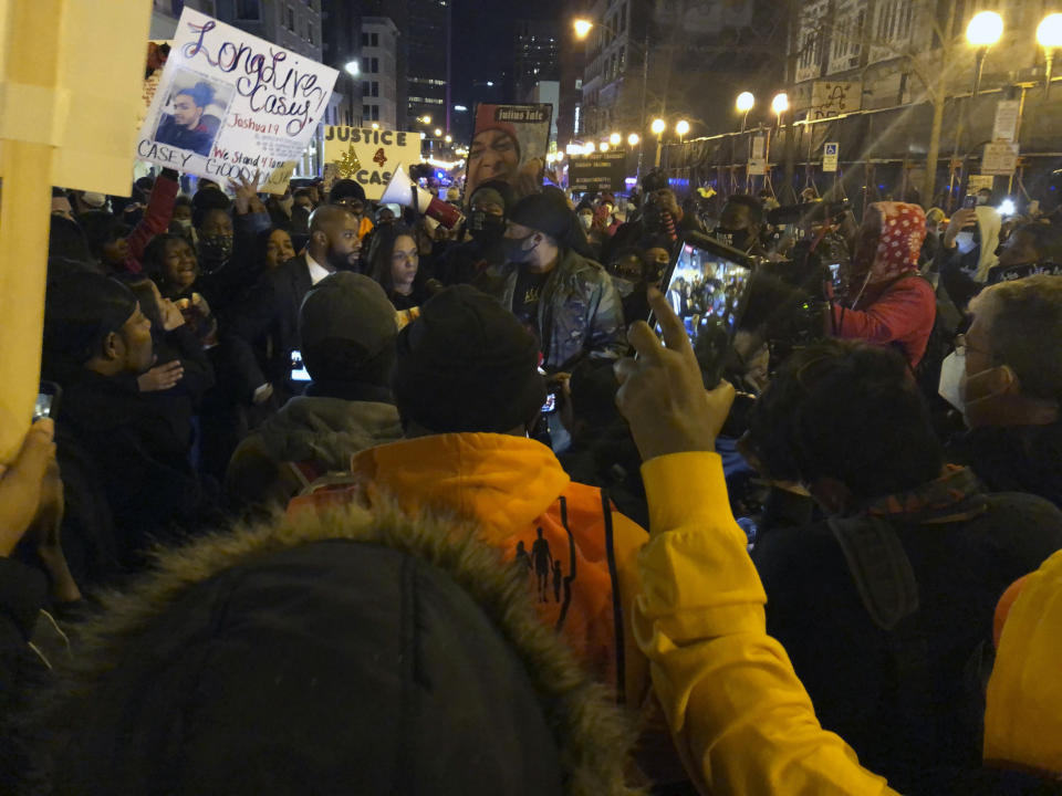 Tamala Payne, center, addresses hundreds of marchers protesting the Dec. 4 fatal shooting of Payne's son, Casey Goodson Jr., who was Black, by a white Ohio sheriff's deputy, on Friday, Dec. 11, 2020, in Columbus, Ohio. Protests were planned Friday and Saturday over the death of Goodson. Columbus police and the U.S. Justice Department are investigating the shooting. (AP Photo/Andrew Welsh-Huggins)