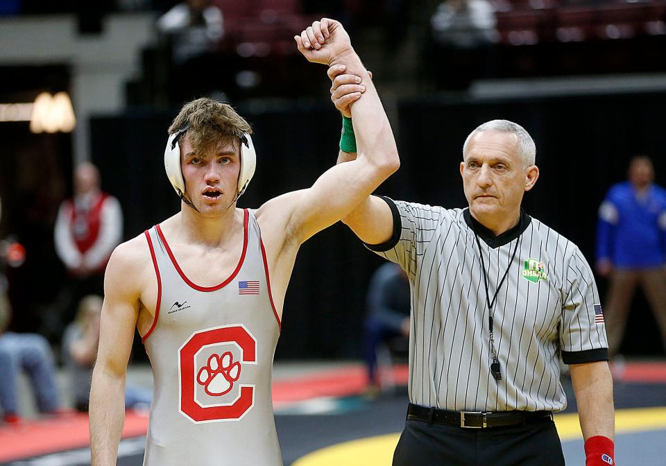 Crestview's Hayden Kuhn has his hand raised after defeating Pleasant's Daxton Chase in overtime during their 144 lbs. match at the OHSAA State Wrestling Championships Sunday, March 12, 2023 at the Jerome Schottenstein Center. . TOM E. PUSKAR/ASHLAND TIMES-GAZETTE