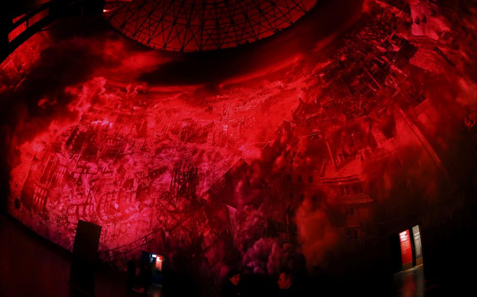 Visitors watch the 'Dresden 1945' 360 degrees panorama showing the destroyed city of Dresden after the bombing raids during the World War Two in February 1945 at the Panometer in Dresden