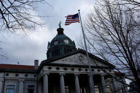 The U.S. flag waves outside the Broome County Courthouse in Binghamton, New York, U.S., April 5, 2018. REUTERS/Andrew Kelly