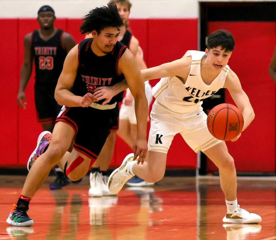 Trinity guard Malachi Farr (L) and Keller guard Parker Hannah (R) go for a loose ball during the second half of a 6A Bi-District High School Basketball playoff game played Monday, February 22, 2021 at Colleyville Heritage High School. (Steve Nurenberg Special to the Star-Telegram)