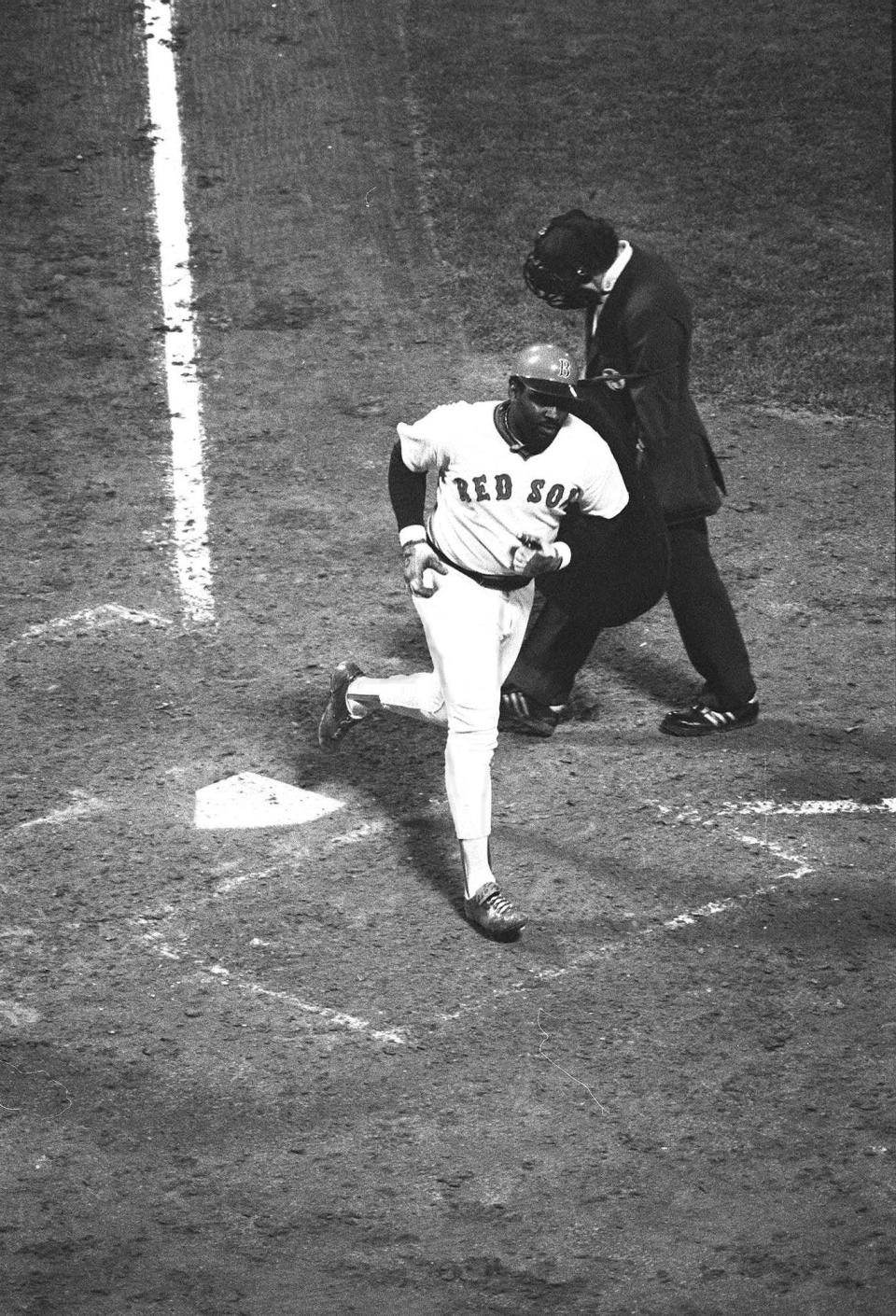 George Scott crosses the plate after hitting a home run in 1977.