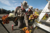 <p>Police move flowers placed at a barricade near the First Baptist Church of Sutherland Springs on Nov. 6, 2017 in Sutherland Springs, Texas. (Photo: Scott Olson/Getty Images) </p>