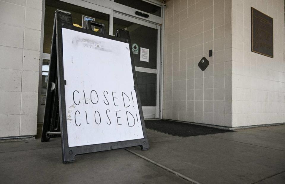 A sign with a handwritten “Closed” sign stands outside Madera Community Hospital’s ER on Monday, July 24, 2023. The hospital closed early this year.