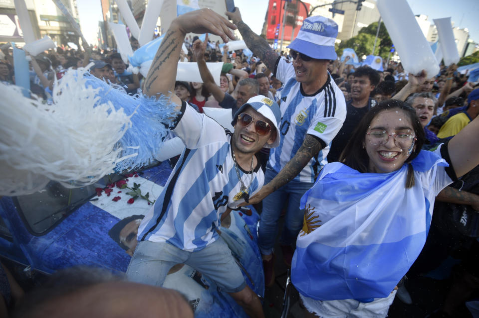 Argentina soccer fans celebrate their team's victory over Croatia at the end of the team's World Cup semifinal match in Qatar after watching it on TV in Buenos Aires, Argentina, Tuesday, Dec. 13, 2022. (AP Photo/Gustavo Garello)