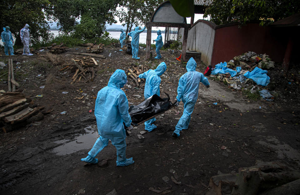 Health workers wearing personal protective equipment carry the body of a COVID-19 victim for cremation in Gauhati, India, Thursday, Sept. 10, 2020. (AP Photo/Anupam Nath)