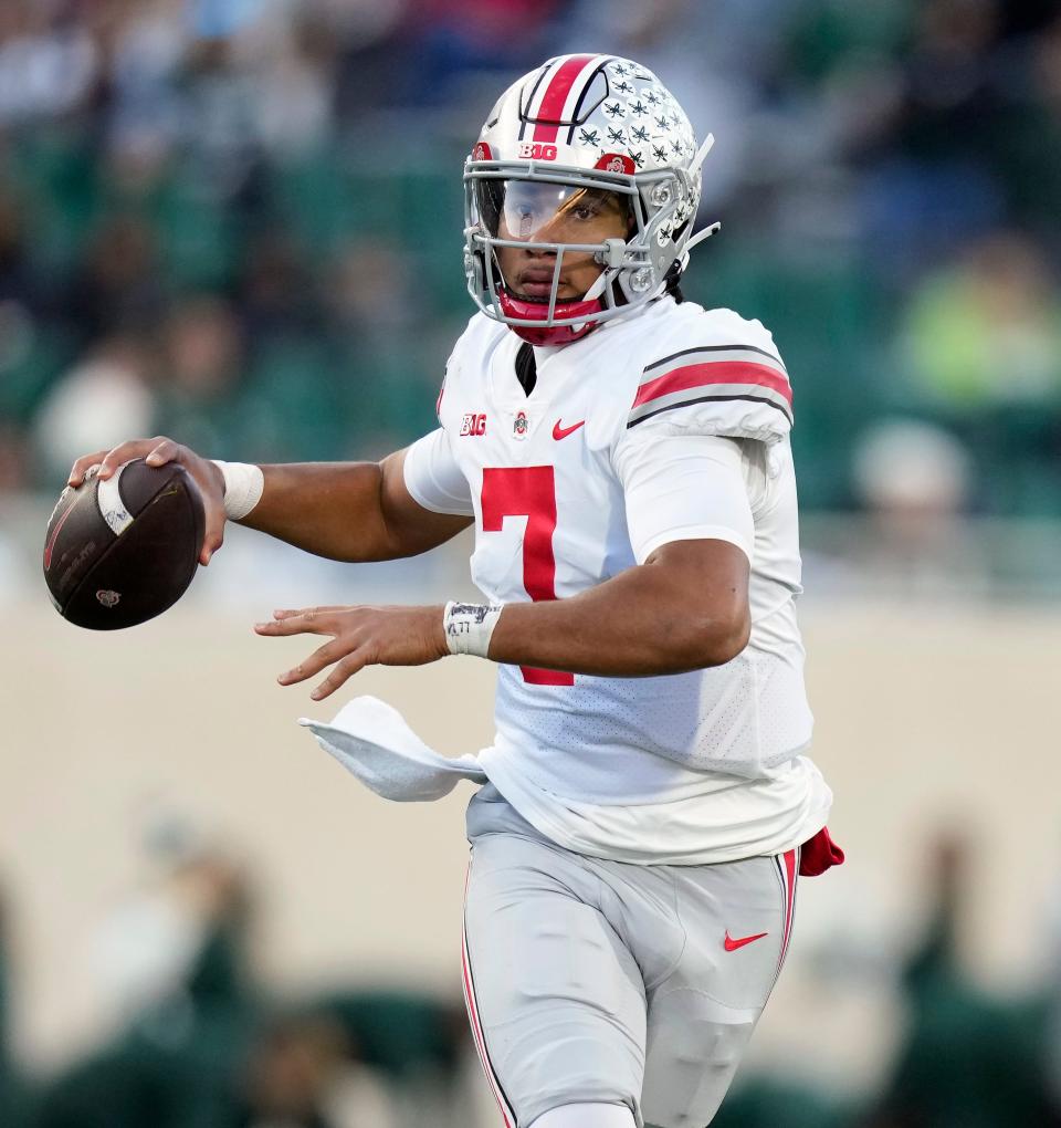 Oct 8, 2022; East Lansing, Michigan, USA; Ohio State Buckeyes quarterback C.J. Stroud (7) throws the ball in the third quarter of the NCAA Division I football game between the Ohio State Buckeyes and Michigan State Spartans at Spartan Stadium. 