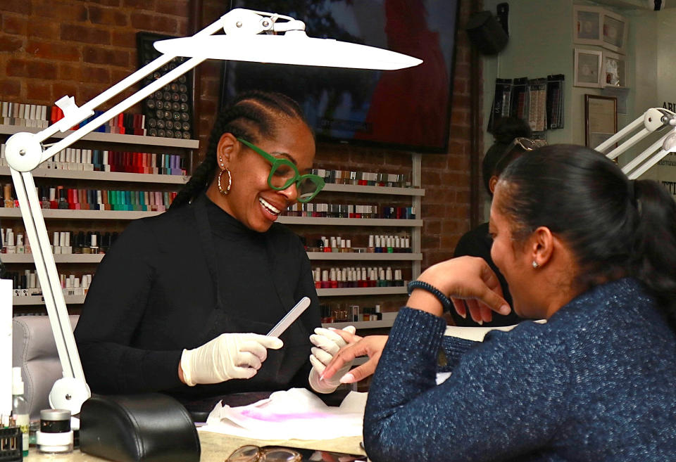 Lisa Logan (left) with a customer at the Nail Suite on Feb. 10, 2023, in Harlem