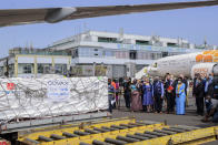 Officials welcome Uganda's first consignment of AstraZeneca COVID-19 vaccine manufactured by the Serum Institute of India and provided through the global COVAX initiative, at the airport in Entebbe, Uganda Friday, March 5, 2021. Urgent calls for COVID-19 vaccine fairness rang through African countries on Friday as more welcomed or rolled out doses from the global COVAX initiative, with officials acutely aware their continent needs much more. (AP Photo/Nicholas Bamulanzeki)