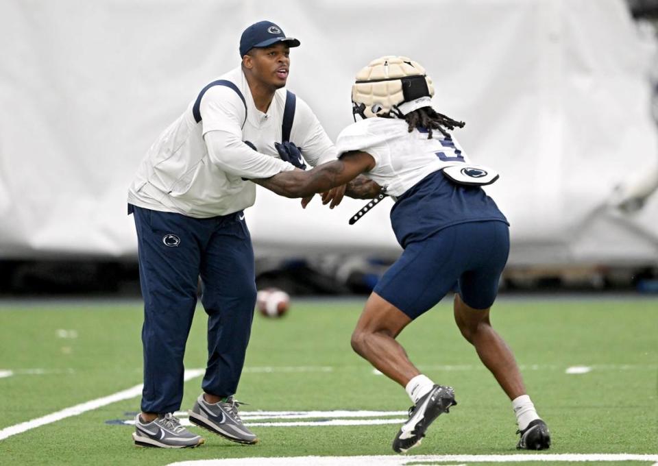Penn State wide receiver coach Marques Hagans tries to block Dante Cephas as he runs a route during practice on Sunday, Aug. 6, 2023.