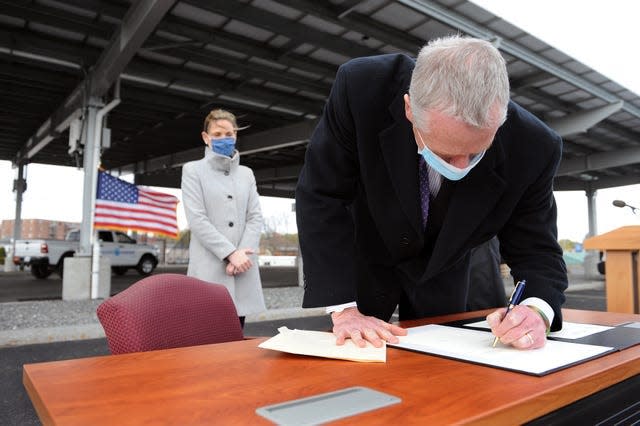 On Earth Day last year, Gov. Charlie Baker was in Framingham to sign an executive order related to reducing greenhouse gas emissions across state facilities. At left is Kathleen Theoharides, secretary of Energy and Environmental Affairs.