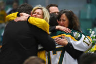 Mourners comfort each other as people attend a vigil at the Elgar Petersen Arena, home of the Humboldt Broncos, to honor the victims of a fatal bus accident in Humboldt, Saskatchewan, Canada. Jonathan Hayward/Pool via REUTERS