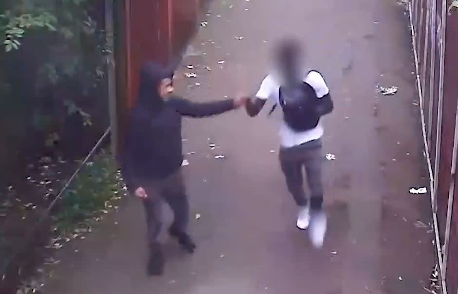 Two teenagers fist bump after a fatal stabbing (Met Police)