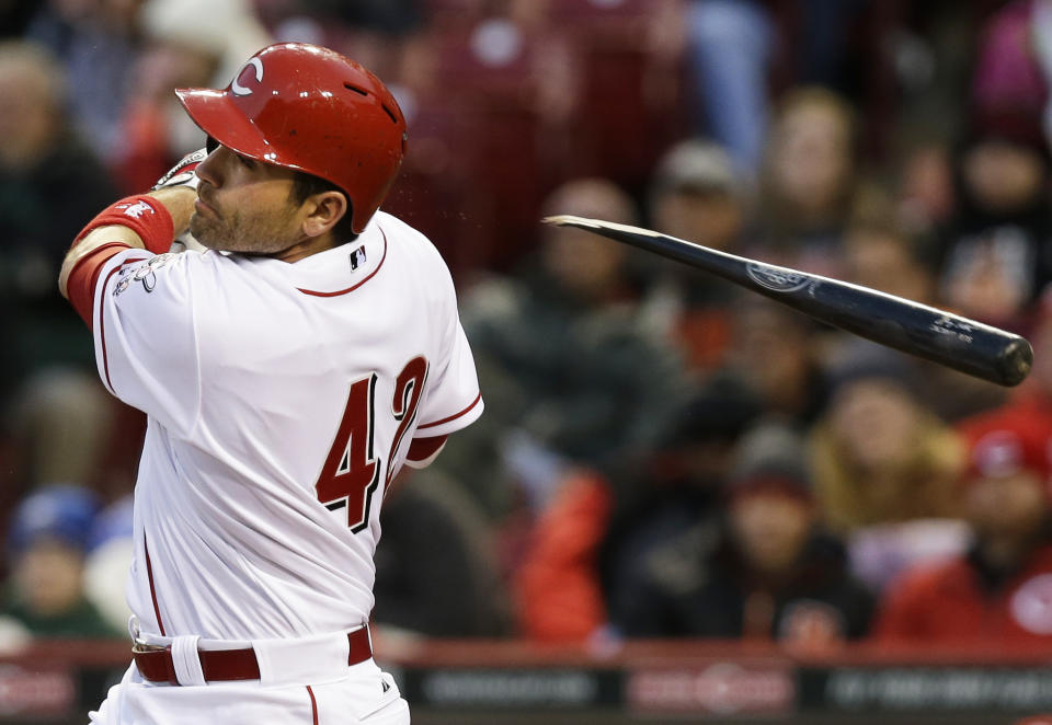 Cincinnati Reds' Joey Votto follows through on a broken-bat single off Pittsburgh Pirates starting pitcher Gerrit Cole to drive in a run in the third inning of a baseball game, Tuesday, April 15, 2014, in Cincinnati. (AP Photo/Al Behrman)