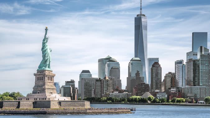 The Statue of Liberty with One World Trade Center background, Landmarks of New York City, USA.