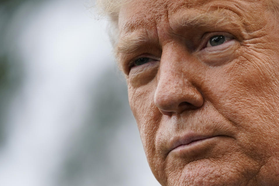 President Donald Trump listens to a reporter's question as he speaks to members of the press on the South Lawn of the White House in Washington, Thursday, Sept. 24, 2020, before boarding Marine One for a short trip to Andrews Air Force Base, Md. Trump is traveling to North Carolina and Florida. (AP Photo/Patrick Semansky)