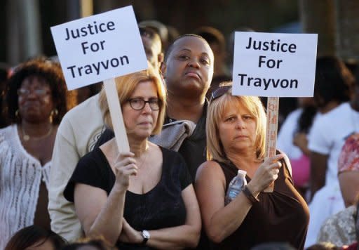 Protesters demonstrate at a rally for slain teenager Trayvon Martin on March 22, in Sanford, Florida. Thousands of people outraged by the fatal shooting of the unarmed black teenager by a white crime watch volunteer gathered to vent their anger and demand justice at a rally in the Florida town