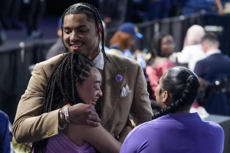 Jett Howard hugs family and friends after being selected 11th overall by the Orlando Magic during the NBA basketball draft, Thursday, June 22, 2023, in New York. (AP Photo/John Minchillo)