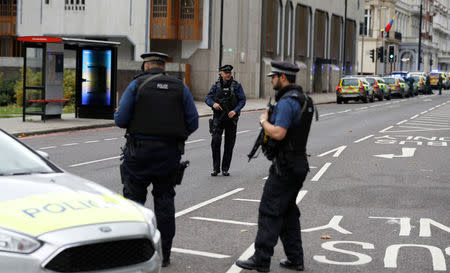 Police officers stand in the road near the Natural History Museum, after a car mounted the pavement injuring a number of pedestrians, police said, in London, Britain October 7, 2017. REUTERS/Peter Nicholls