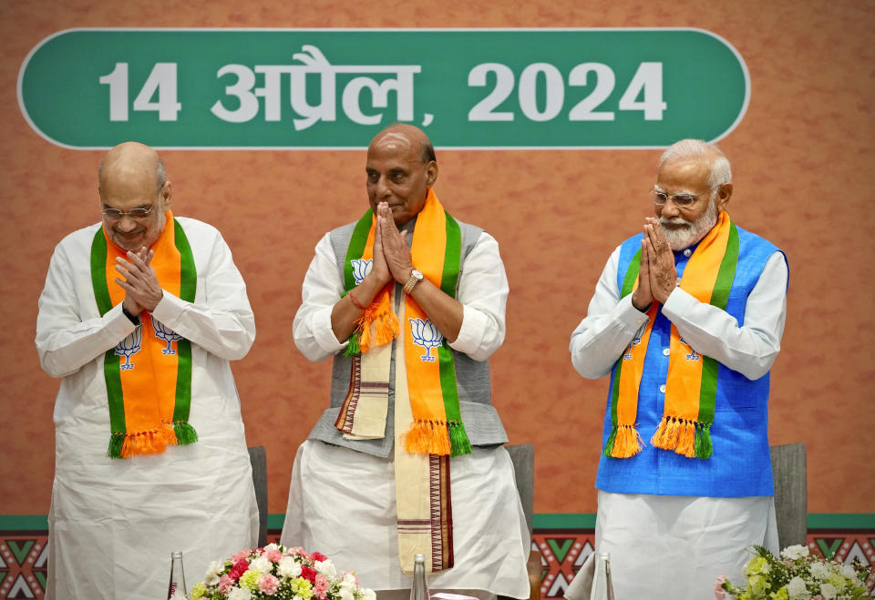 Indian Prime Minister Narendra Modi, right, stands with senior Bharatiya Janata Party (BJP) leaders, Home Minister Amit Shah, Defence Minister Rajnath Singh, center, at an event during which he released BJP's manifesto for the upcoming national parliamentary elections in New Delhi, India, Sunday, April 14, 2024.(AP Photo/Manish Swarup)