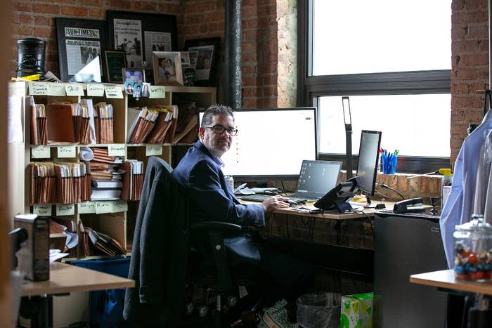 An attorney in a suit sits in a crowded office