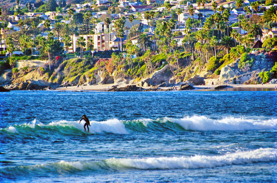 Person surfs waves at Laguna Beach