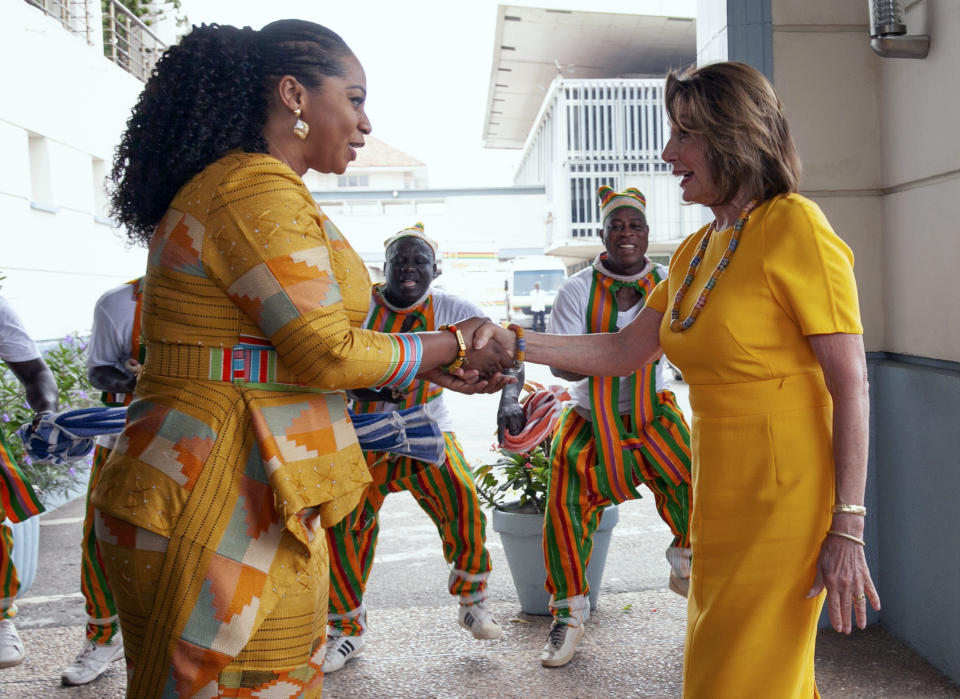 US House Speaker Nancy Pelosi shakes hands with Hon. Sarah Adwoa Sarfo outside Ghana's Parliament in Accra, Ghana, Wednesday, July 31, 2019. U.S. House Speaker Nancy Pelosi is in Ghana as the head of a Congressional delegation to address Ghana's lawmakers on Wednesday. While in Ghana, Pelosi and other members of the U.S. Congress plan discussions on "regional security, sustainable and inclusive development and the challenges of tomorrow including the climate crisis." (AP Photo/Christian Thompson) hake with Ghanas Menbers of Paliament as she exit the chamber. Ghana,Accra. 31 jul;y 2019 AP IMAGES/CHRISTIAN THOMPSON