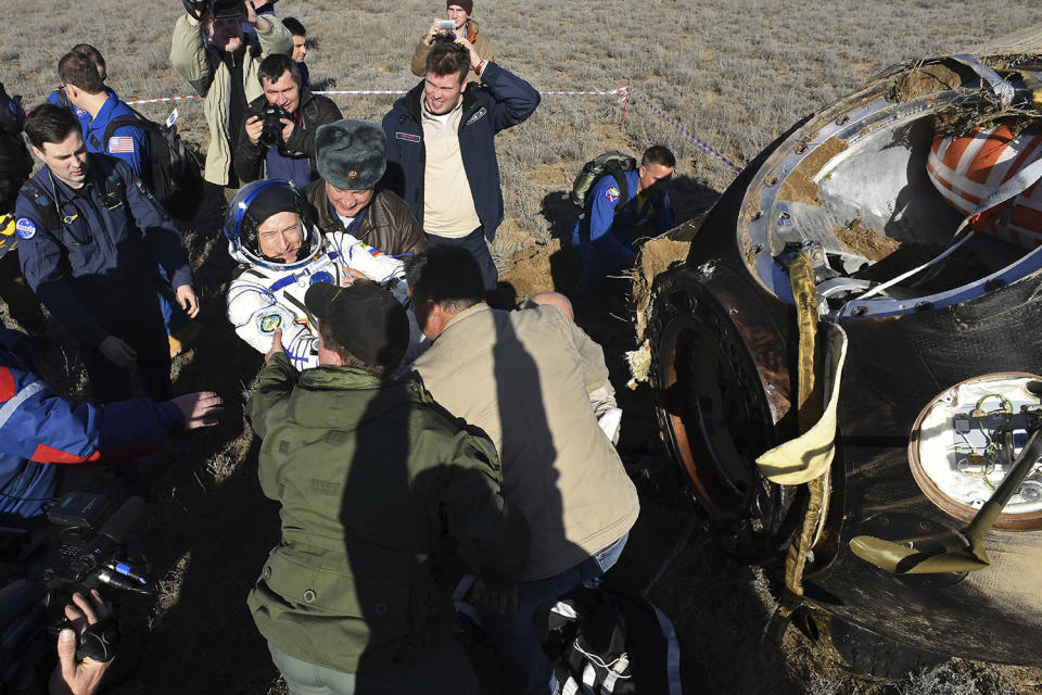 Assisting cosmonaut Sergey Ryzhikov