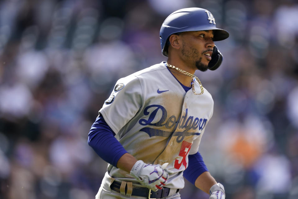 Los Angeles Dodgers' Mookie Betts runs up the first base line after popping out against Colorado Rockies relief pitcher Mychal Givens in the ninth inning of a baseball game Sunday, April 4, 2021, in Denver. The Dodgers won 4-2. (AP Photo/David Zalubowski)