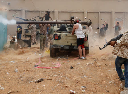 A fighter loyal to Libya's U.N.-backed government (GNA) fires a 105 mm recoilless rifle during clashes with forces loyal to Khalifa Haftar on the outskirts of Tripoli, Libya May 25, 2019. REUTERS/Goran Tomasevic