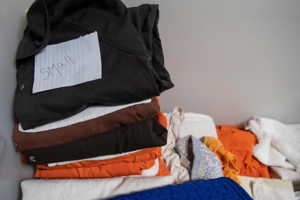 A stack of clothes labeled "small" in the women's quarters at the Buncombe County Detention Center December 2, 2021.