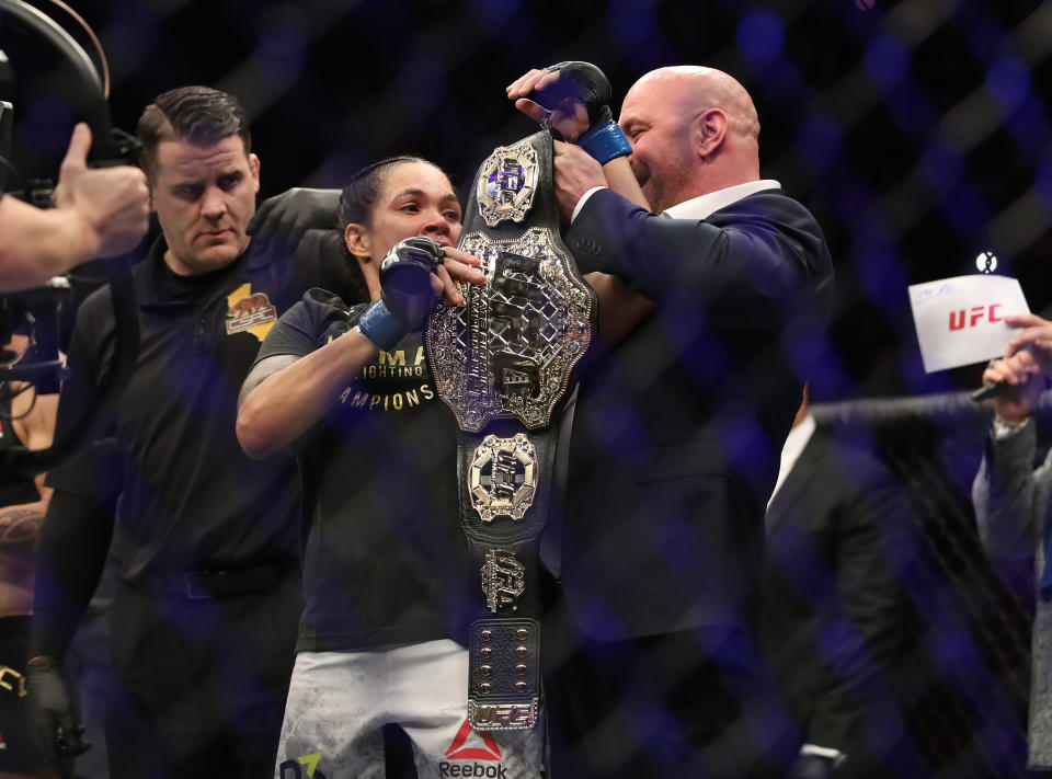 Dana White hands Amanda Nunes two UFC championship belts after defeating Cris Cyborg in their women’s featherweight bout during the UFC 232 event inside The Forum on Dec. 29, 2018 in Inglewood, California. (Getty Images)