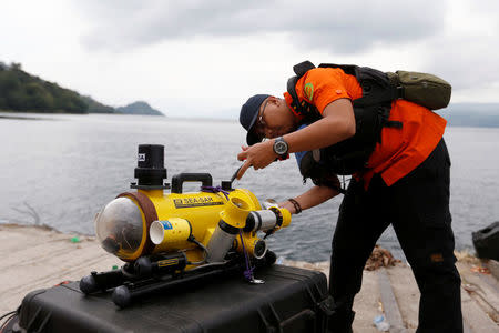 A rescue team member prepares a ROV (Remote Operated Vehicle) during search operations for the missing passengers from a ferry accident at Lake Toba at Tigaras port in Simalungun, North Sumatra, Indonesia June 21, 2018. REUTERS/Beawiharta
