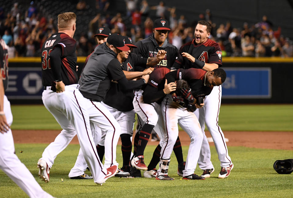 PHOENIX, ARIZONA - JUNE 01: Tim Locastro #16 of the Arizona Diamondbacks celebrates a walk off RBI single with Jarrod Dyson #1, Nick Ahmed #13 and teammates against the New York Mets during the eleventh inning at Chase Field on June 01, 2019 in Phoenix, Arizona. Diamondbacks won 6-5. (Photo by Norm Hall/Getty Images)