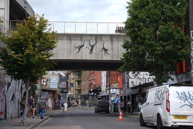 The three monkeys on a bridge in Brick Lane, east London