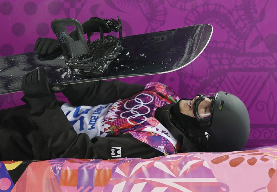 Switzerland's Iouri Podladtchikov rests after his first half pipe run during the men's snowboard halfpipe final at the Rosa Khutor Extreme Park, at the 2014 Winter Olympics, Tuesday, Feb. 11, 2014, in Krasnaya Polyana, Russia. Podladtchikov won the gold medal..(AP Photo/Andy Wong)