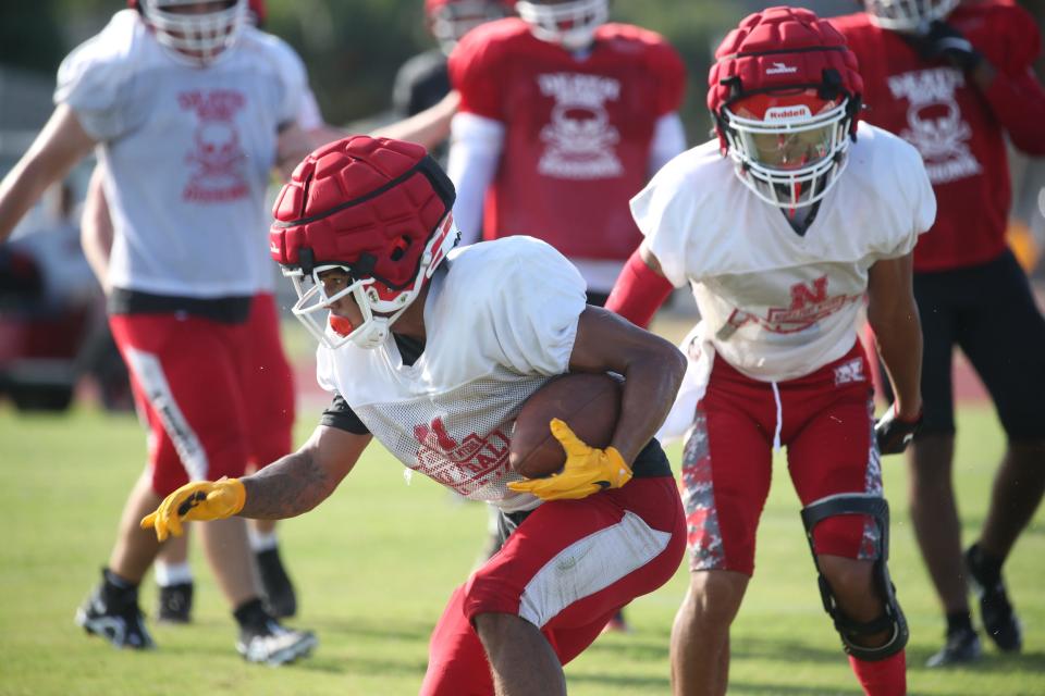 Andre Devine of North Fort Myers High School runs the ball during a scrimmage on Saturday morning, Aug. 13, 2022, during their football fan day event.