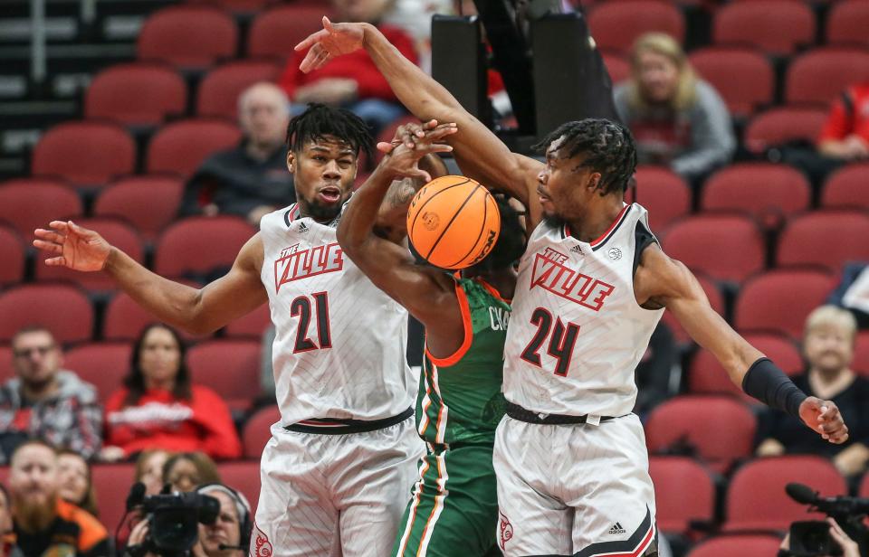 Louisville's Sydney Curry, left, and Louisville's Jae'Lyn Withers pressure Florida A&'s Jordan Chatman in the first half at the YUM! Center in Downtown Louisville Saturday. Louisville won 61-55. Dec. 17, 2022