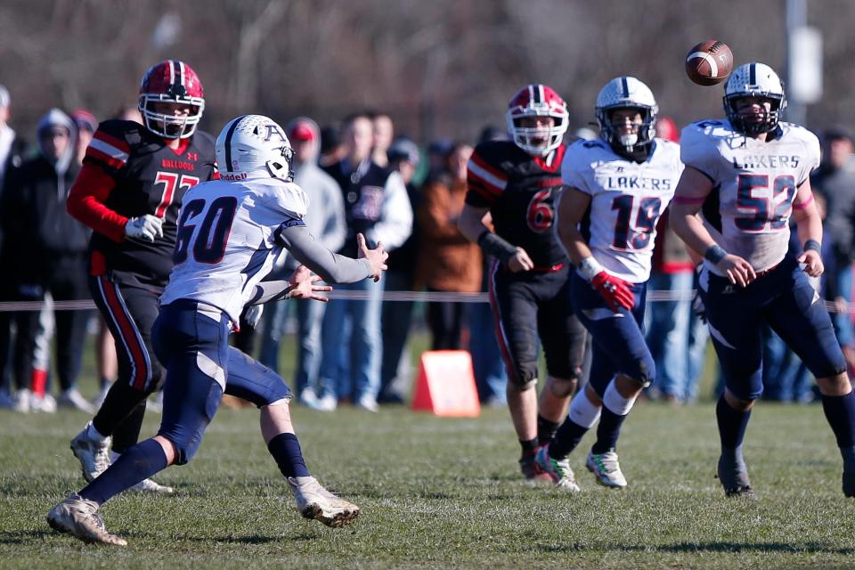 Apponequet's Jackson Moore makes the interception for a pick-six at the Apponequet High School versus Old Rochester Regional High School Thanksgiving Day football game held at ORR.