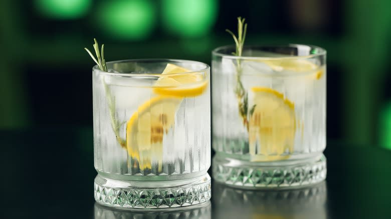 Two glasses with lemon and herb