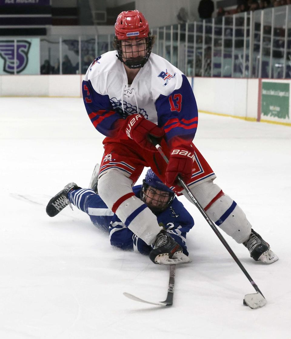 Bridgewater-Raynham's Bobby Quill was tripped by Scituate's Shawn Patrick McGuiggin during a game on Saturday, Feb. 4, 2023.