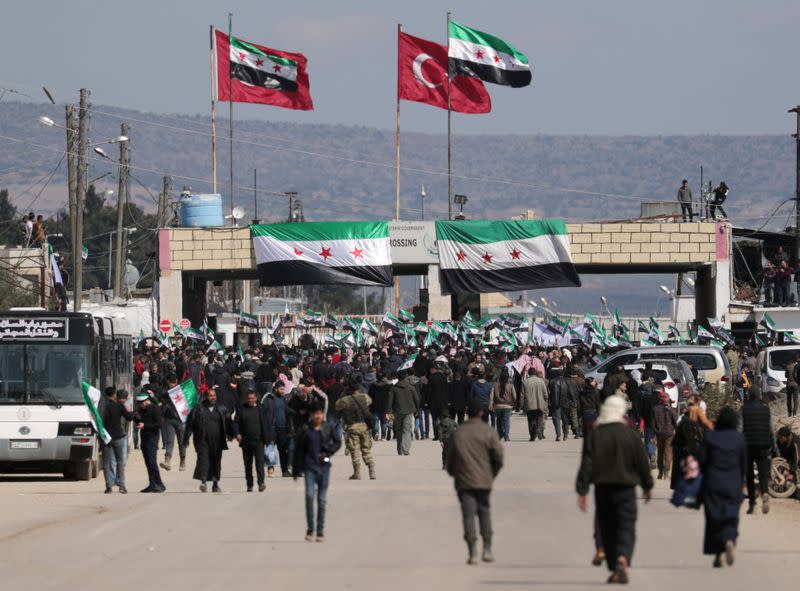 FILE PHOTO: Internally displaced Syrians hold Syrian opposition flags during a protest in support of the Turkish army and Turkey backed Syrian rebels at the Bab el-Salam border crossing between the Syrian town of Azaz and the Turkish town of Kilis