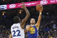 December 10, 2018; Oakland, CA, USA; Golden State Warriors guard Stephen Curry (30) shoots the basketball against Minnesota Timberwolves forward Andrew Wiggins (22) during the third quarter at Oracle Arena. Kyle Terada-USA TODAY Sports