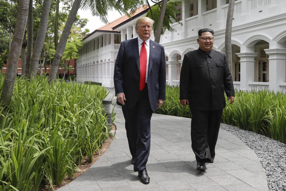 U.S. President Donald Trump and North Korea leader Kim Jong Un walk from their lunch at the Capella resort on Sentosa Island Tuesday, June 12, 2018 in Singapore. (AP Photo/Evan Vucci)