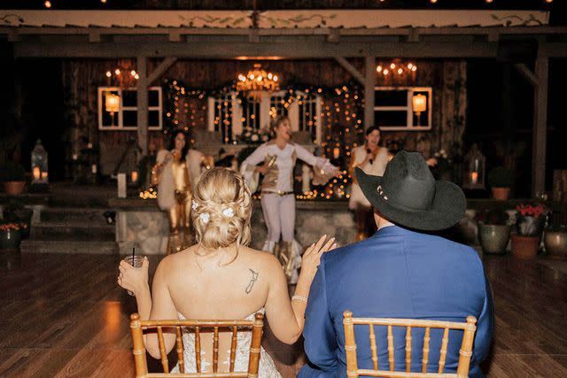 <p>Darian Shantay</p> Bride Mercedes Cloward and her husband watch Cloward's mother Heather Hagen perform at her wedding in Oak Glen, California