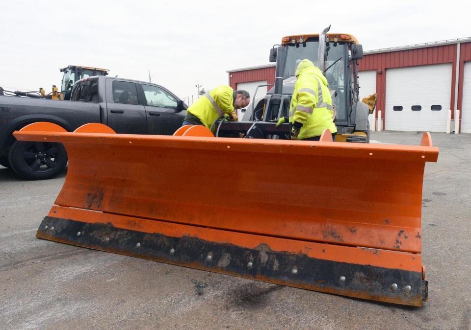 Brockton Department of Public Works employees prepare snowplows on Friday, Jan. 28, 2022, for this weekend's historic snowstorm that could bring more than 2 feet of snow to the region.